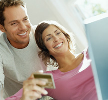 couple with computer and credit card